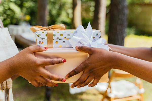 Hands Giving and Receiving Wrapped Presents